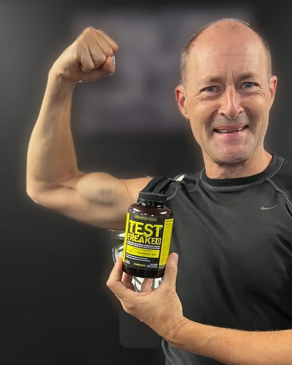 Glen after, flexing and holding a bottle of Test Freak